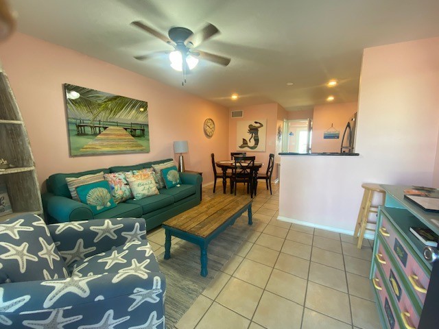 2290 North Fulton Beach Road, Unit A113 Rockport, TX 78382 - Photo 3 of 13 a living room with furniture and a chandelier