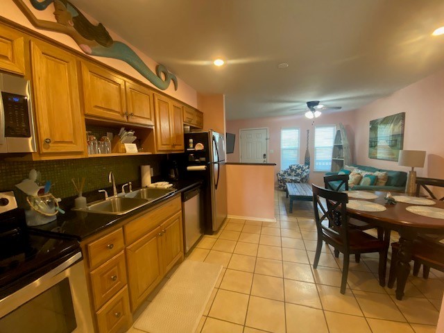 2290 North Fulton Beach Road, Unit A113 Rockport, TX 78382 - Photo 5 of 13 a kitchen with stainless steel appliances granite countertop a stove a sink dishwasher and cabinets with wooden cabinets