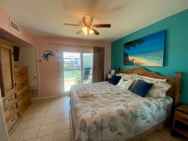 2290 North Fulton Beach Road, Unit A113 Rockport, TX 78382 - Photo 6 of 13 a bedroom with a large bed and a flat tv screen on dresser