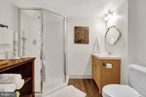 a bathroom with a toilet and a mirror