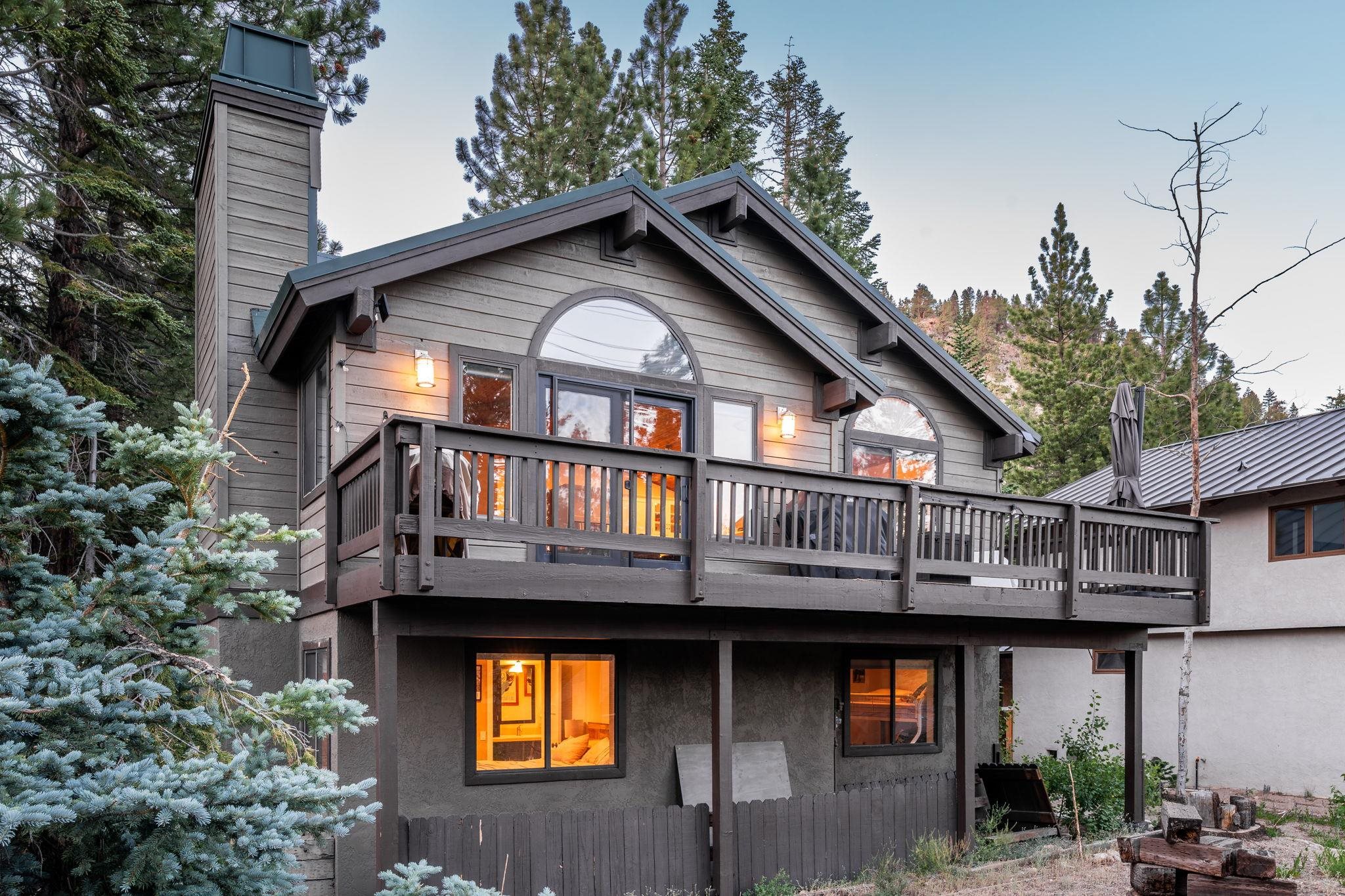 2 Holiday Way Mammoth Lakes, CA 93546 - Photo 25 of 37 a view of a house with large windows and a small yard