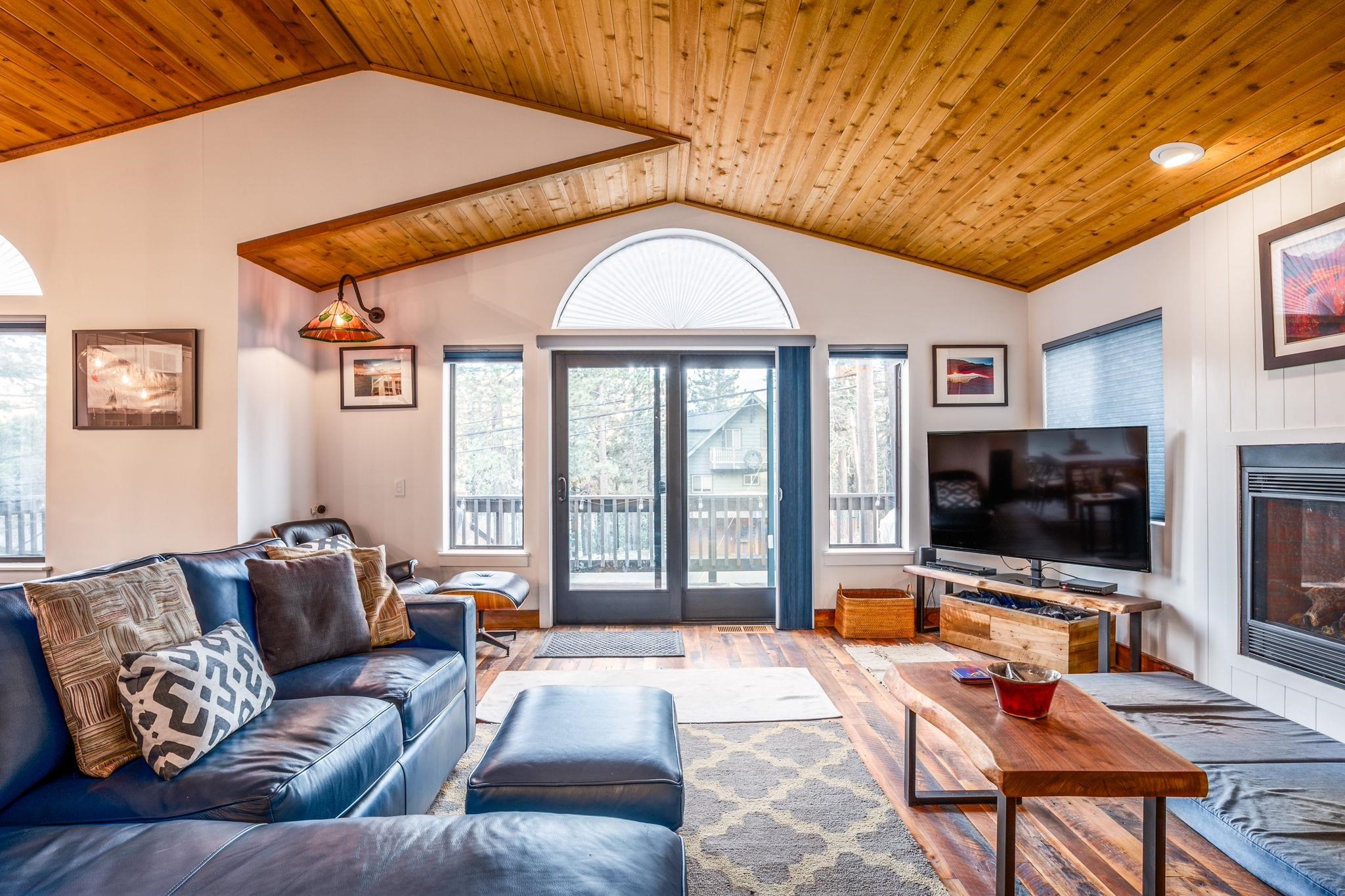 2 Holiday Way Mammoth Lakes, CA 93546 - Photo 6 of 37 a living room with furniture a flat screen tv and a floor to ceiling window