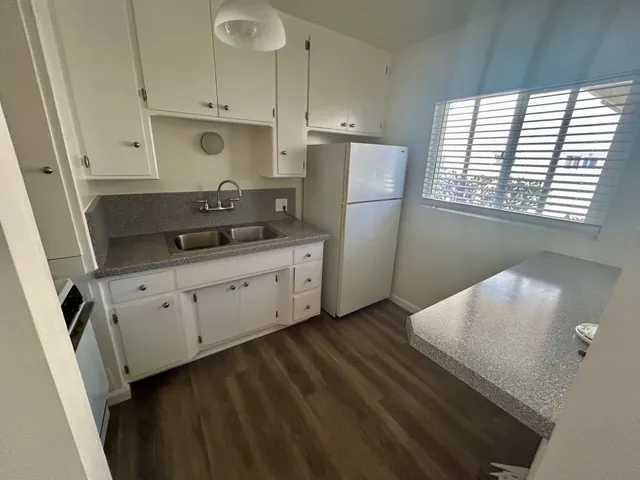 a kitchen with stainless steel appliances a refrigerator sink and cabinets