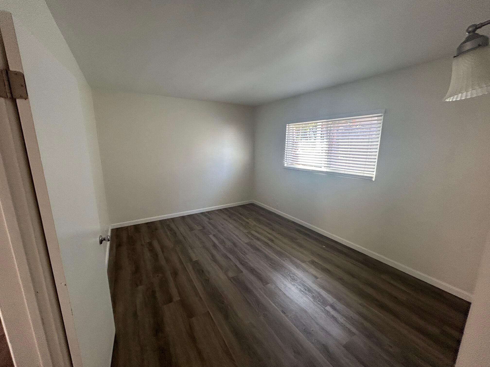 326 West Anapamu Street, Unit B Santa Barbara, CA 93101 - Photo 4 of 5 an empty room with wooden floor and windows
