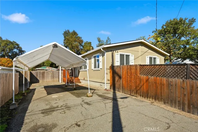 a view of a house with wooden fence