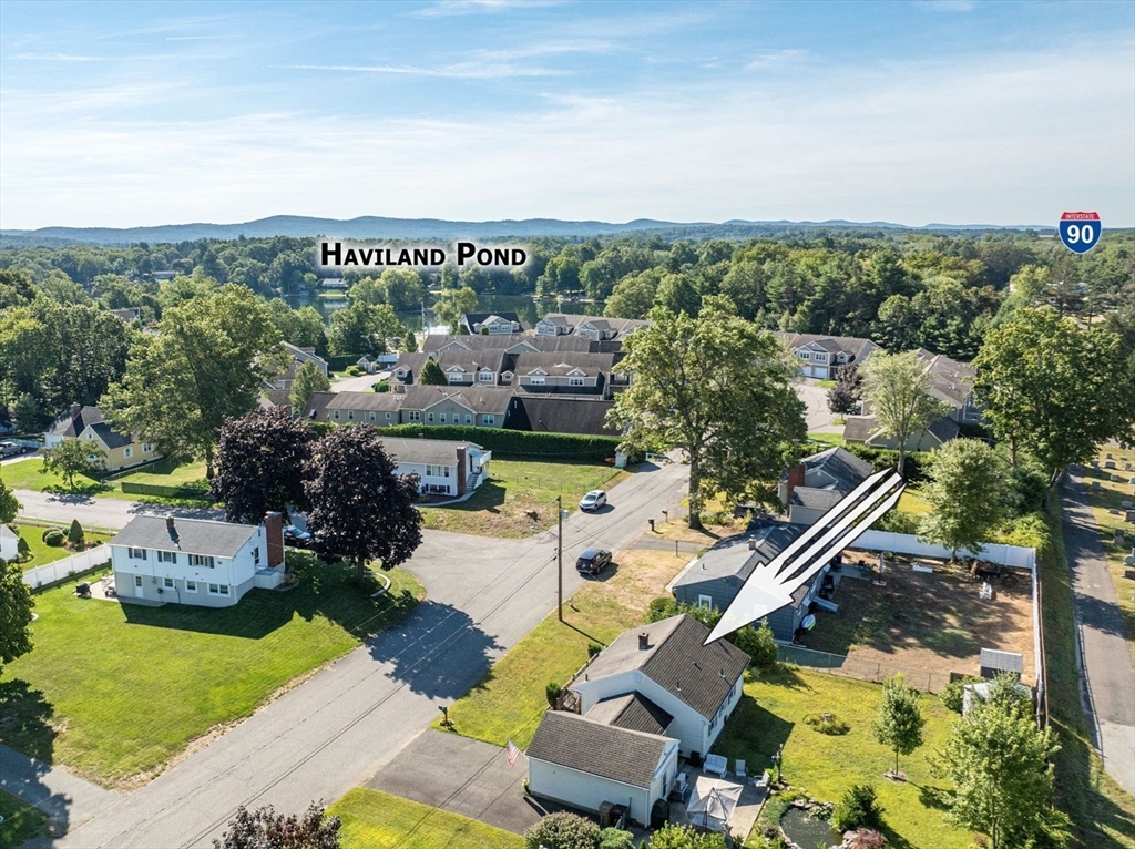 an aerial view of a house with swimming pool garden and patio