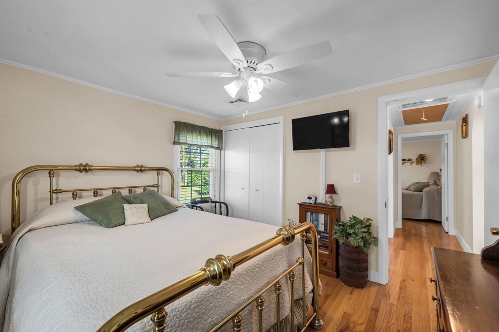 34 Adams Street Ludlow, MA 01056 - Photo 22 of 42 a bedroom with a bed and a flat tv screen on dresser