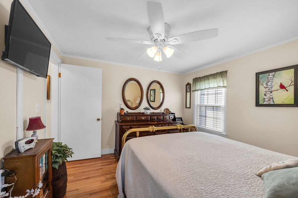 34 Adams Street Ludlow, MA 01056 - Photo 24 of 42 a bedroom with a bed and a chandelier