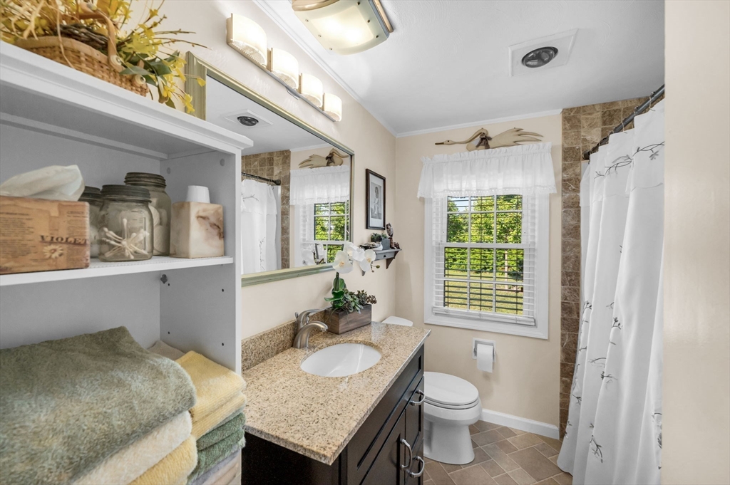 34 Adams Street Ludlow, MA 01056 - Photo 26 of 42 a bathroom with a granite countertop sink and a mirror