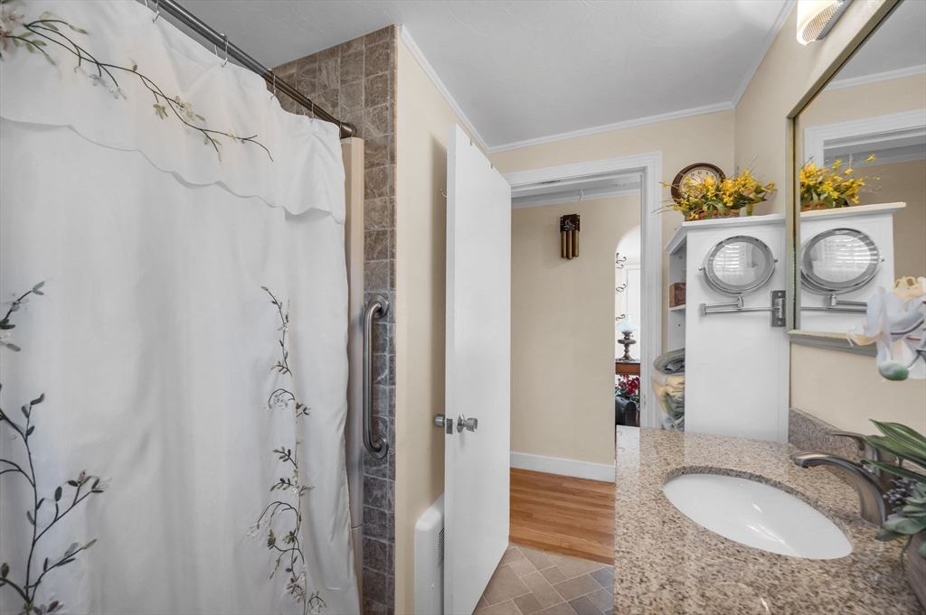 34 Adams Street Ludlow, MA 01056 - Photo 28 of 42 a bathroom with a granite countertop shower sink and mirror