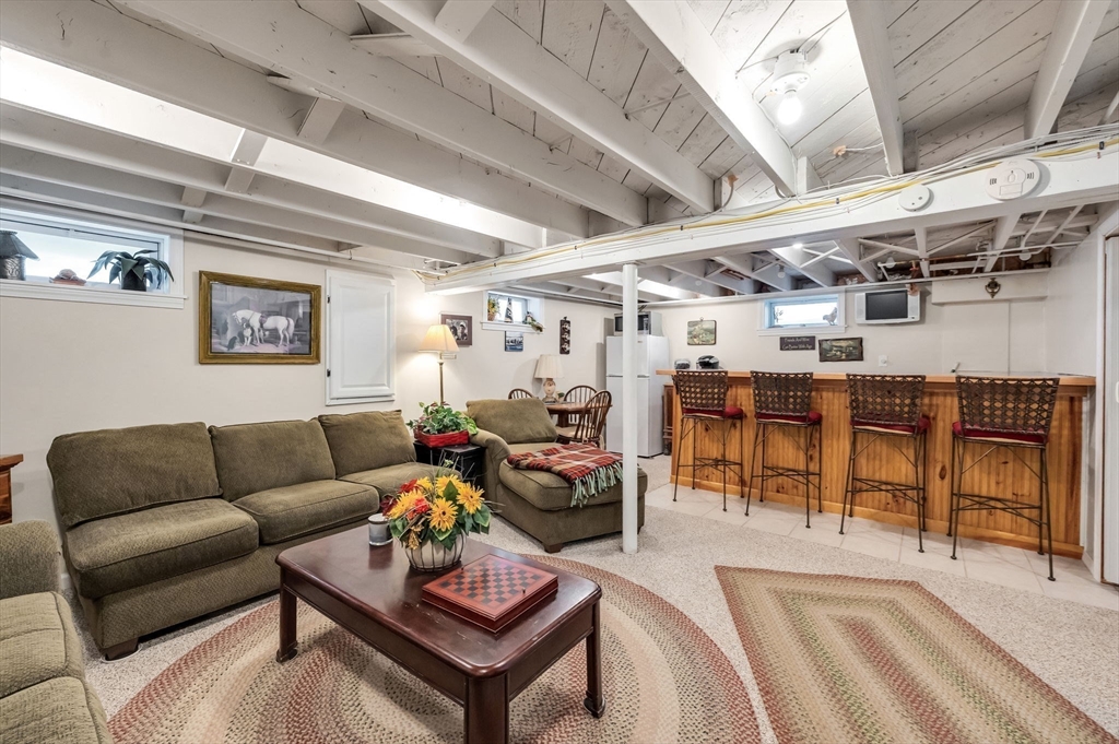34 Adams Street Ludlow, MA 01056 - Photo 32 of 42 a living room with furniture and a chandelier