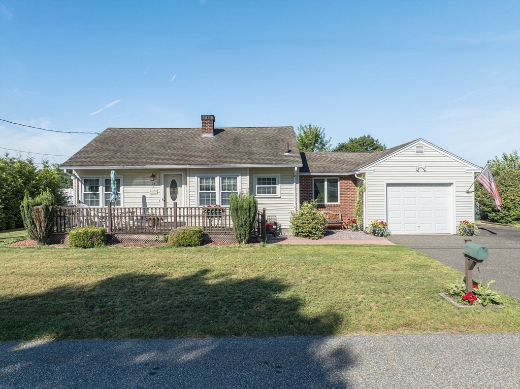 34 Adams Street Ludlow, MA 01056 - Photo 6 of 42 a front view of a house with a garden and porch
