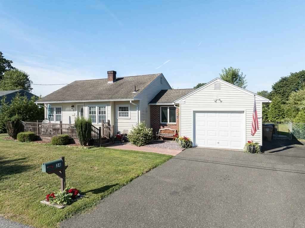 34 Adams Street Ludlow, MA 01056 - Photo 7 of 42 a front view of a house with a yard and garage