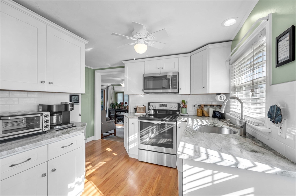 34 Adams Street Ludlow, MA 01056 - Photo 9 of 42 a kitchen with stainless steel appliances granite countertop a sink stove and refrigerator