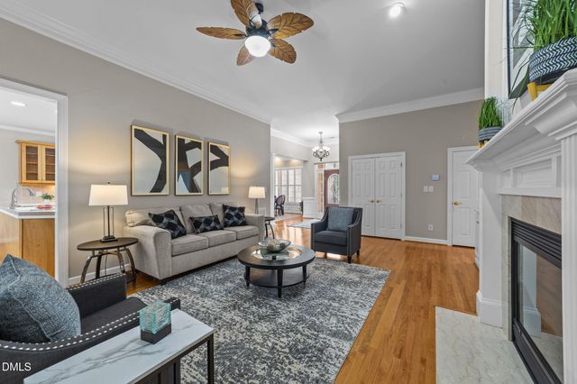 a living room with furniture fireplace and window