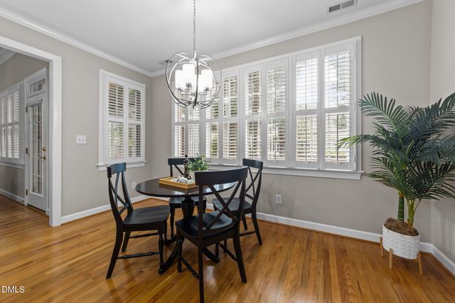 a kitchen with sink a refrigerator and chairs