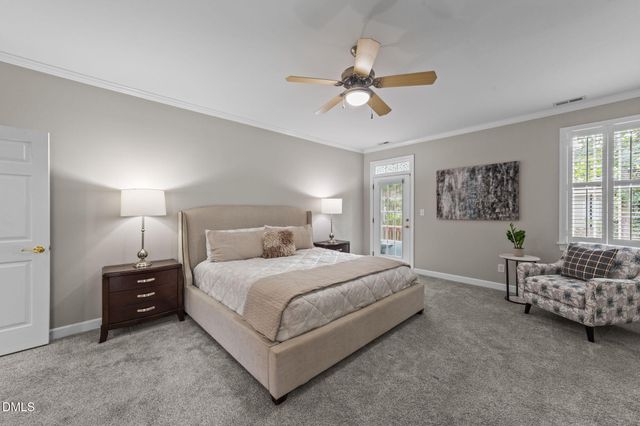 a bedroom with a bed and ceiling fan