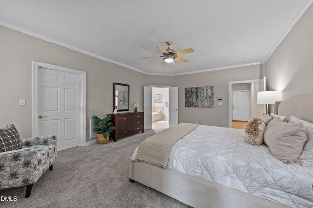 a spacious bedroom with a bed a dresser and couch