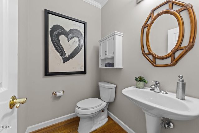 a bathroom with a toilet a sink and a mirror