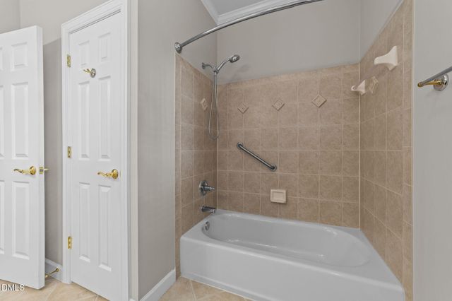 a white bath tub sitting next to a shower