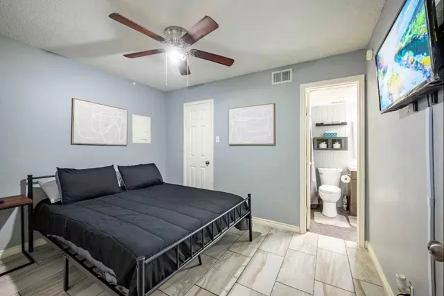 a bedroom with a bed and a flat screen tv