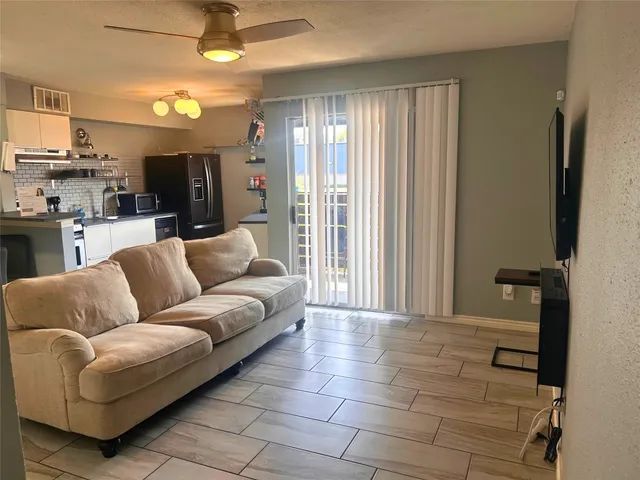 a living room with furniture and a large window
