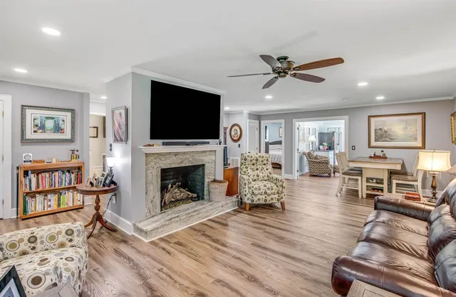 a living room with furniture a flat screen tv and a fireplace