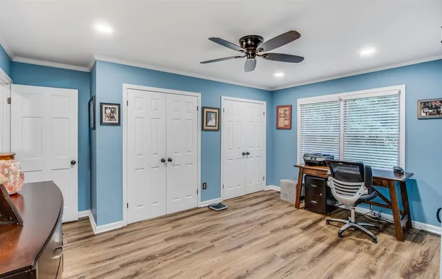 a view of a workspace with furniture and windows