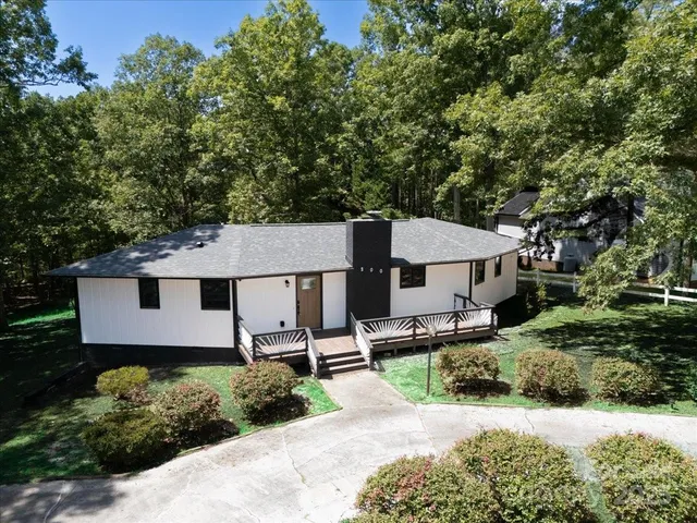 a aerial view of a house with a yard and sitting area