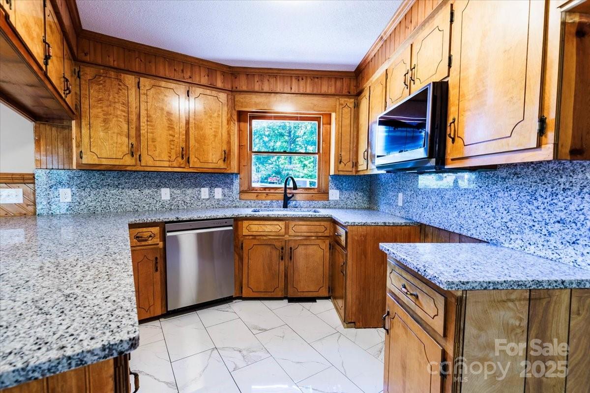 200 Lakeview Road Albemarle, NC 28001 - Photo 6 of 11 a kitchen with granite countertop a sink a stove and cabinets