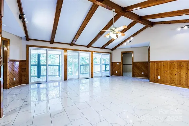 a big room with chandelier and furniture