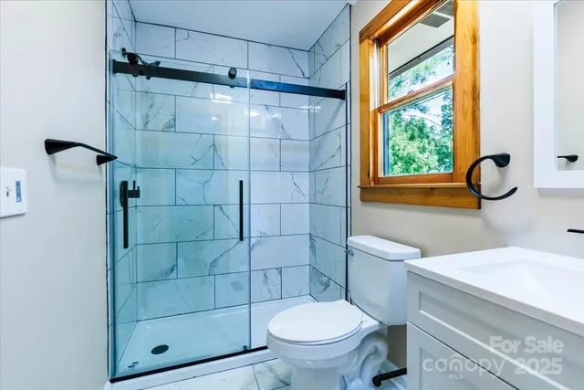 a bathroom with a toilet and a shower