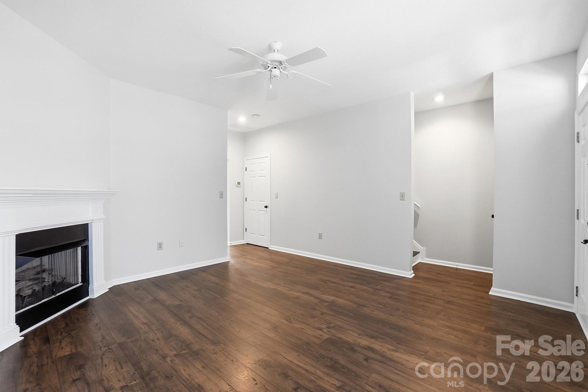 711 Stone Village Drive Fort Mill, SC 29708 - Photo 10 of 46 an empty room with wooden floor and a fireplace