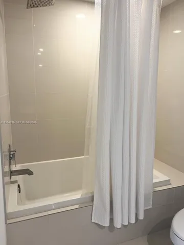 a bathroom with bathtub and shower