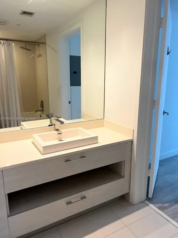 a bathroom with a double vanity sink and a mirror