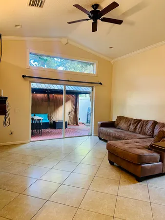 a living room with a couch and a floor to ceiling window