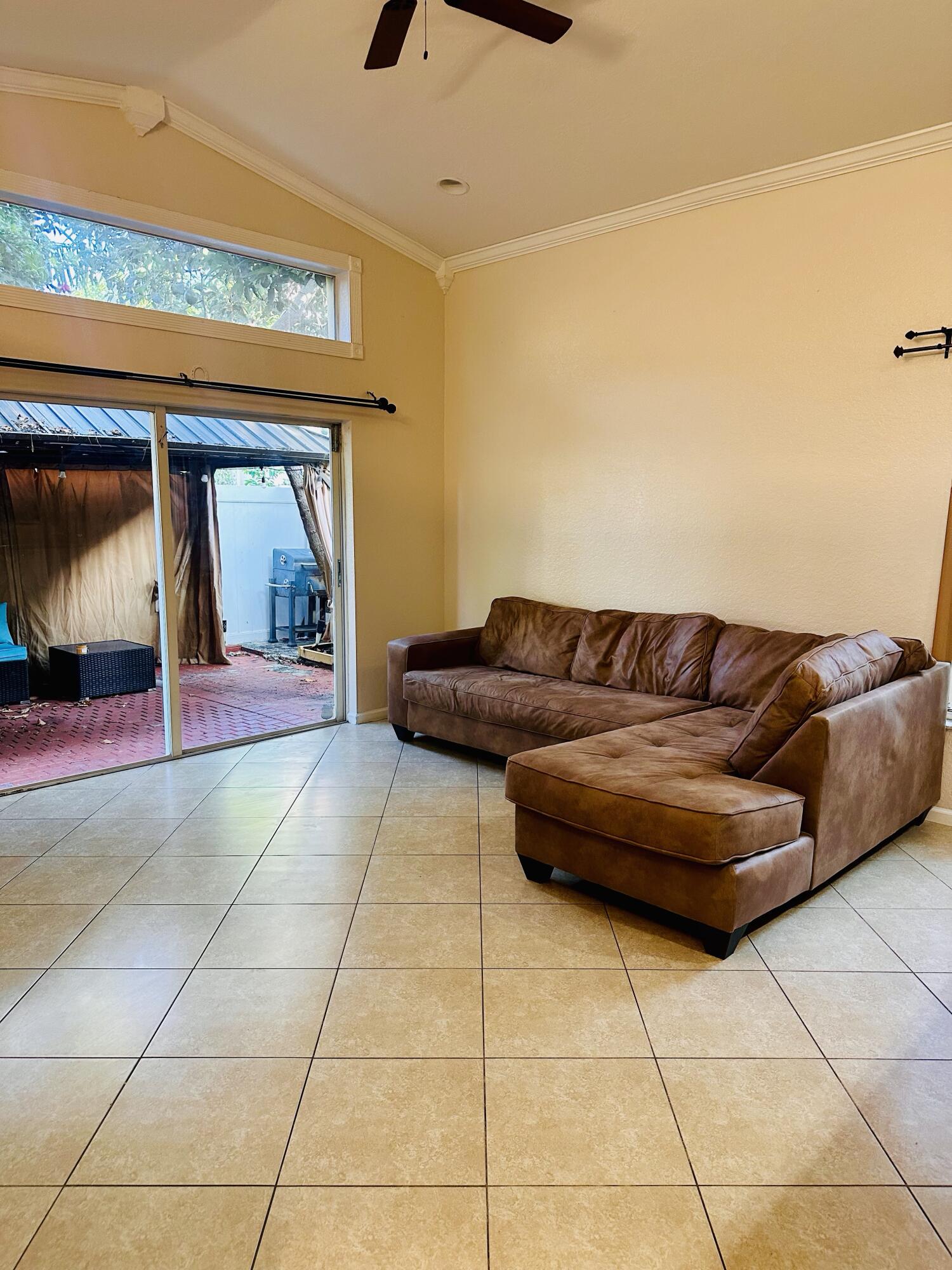 5200 Rising Comet Lane Greenacres, FL 33463 - Photo 17 of 50 a living room with a couch and a rug