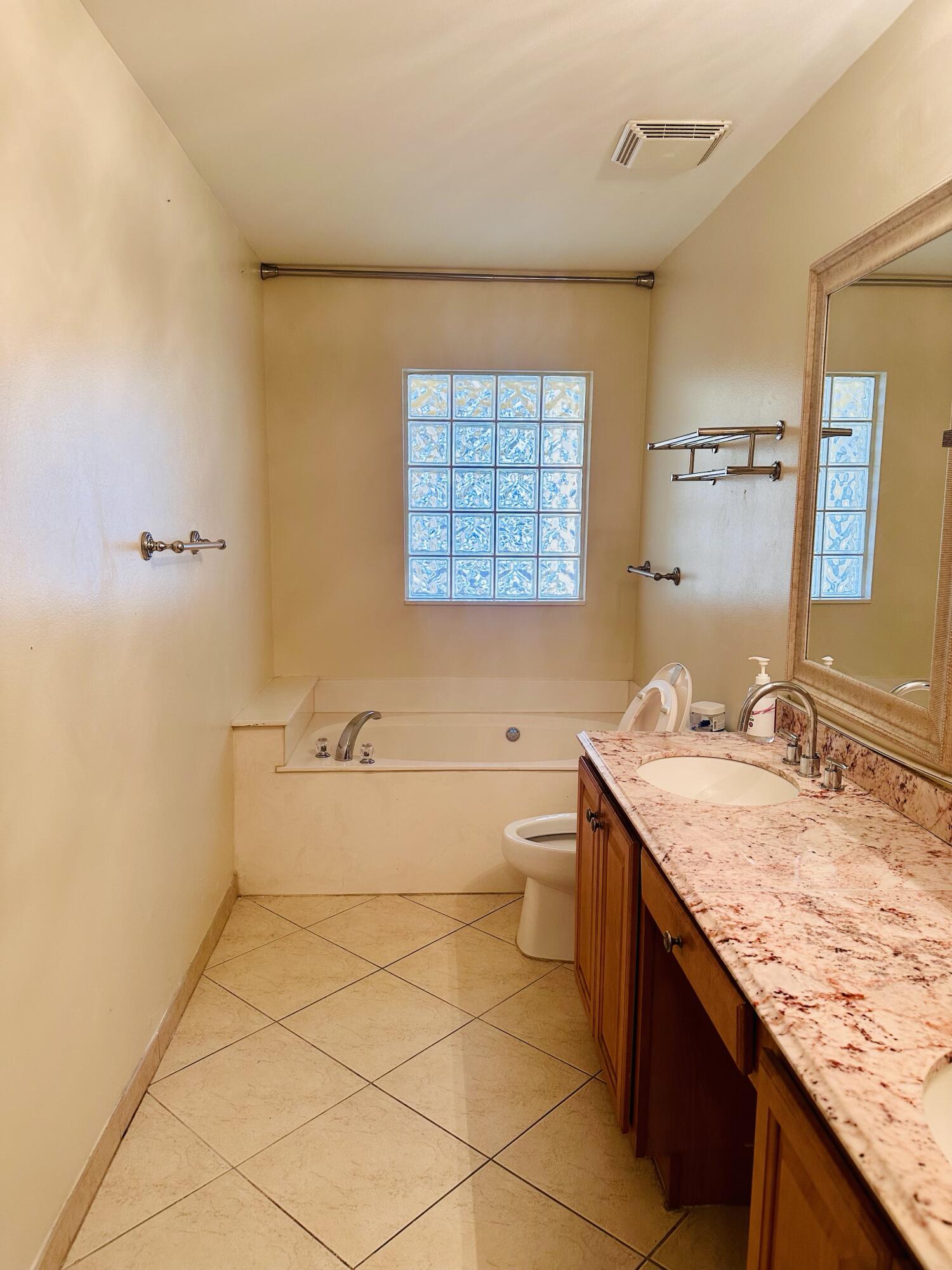 5200 Rising Comet Lane Greenacres, FL 33463 - Photo 22 of 50 a bathroom with a granite countertop sink a toilet and bathtub