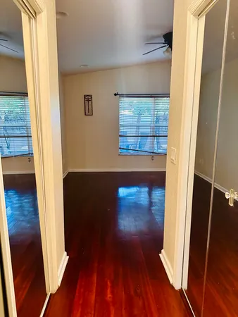 a view of a hallway with wooden floor