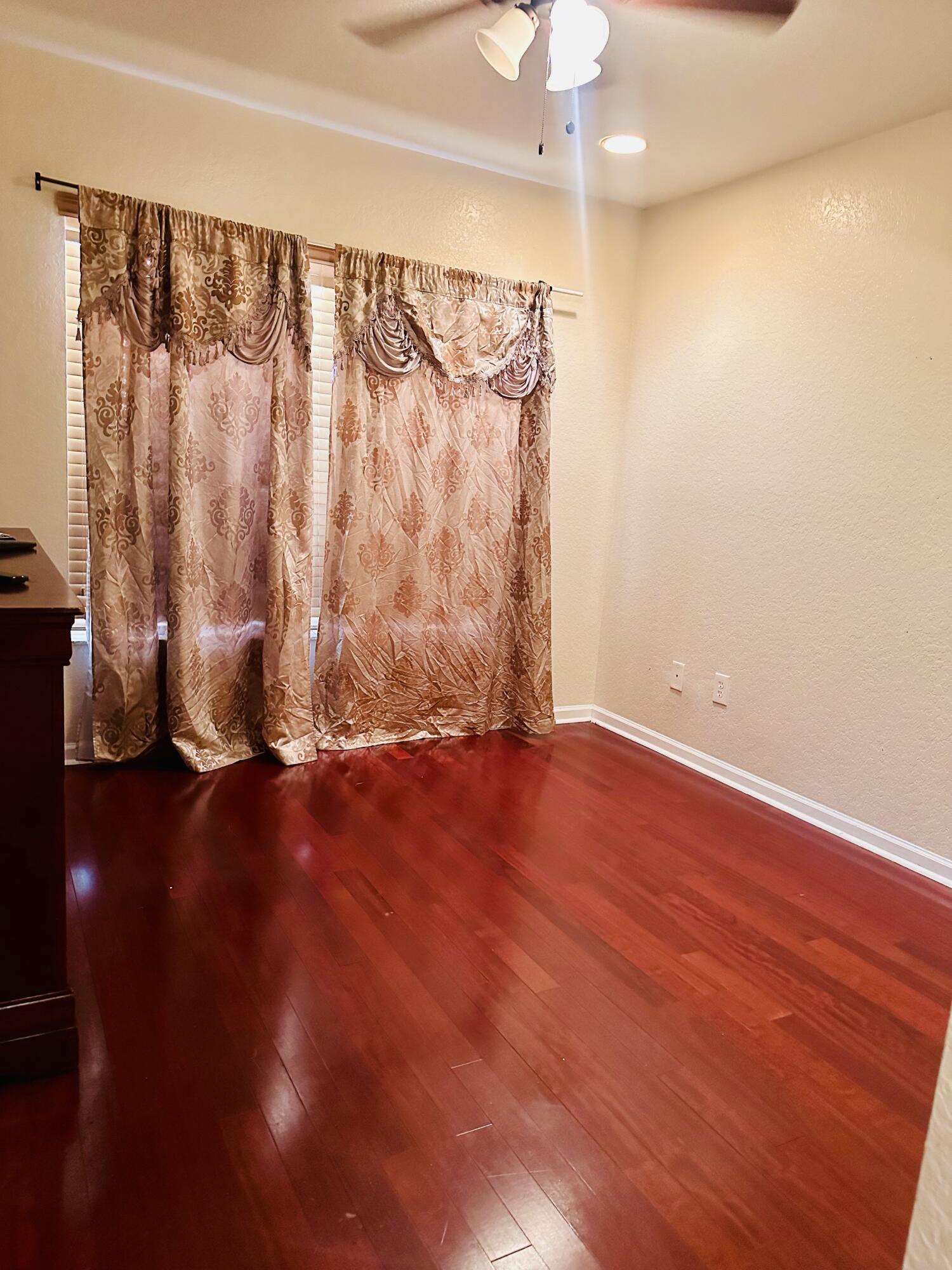 5200 Rising Comet Lane Greenacres, FL 33463 - Photo 30 of 50 a view of an empty room with wooden floor and a window
