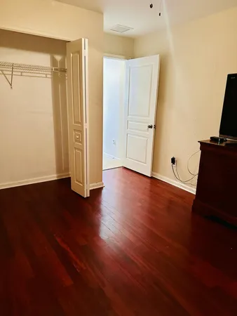 a view of an empty room with wooden floor