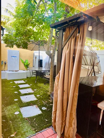 a backyard of a house with table and chairs