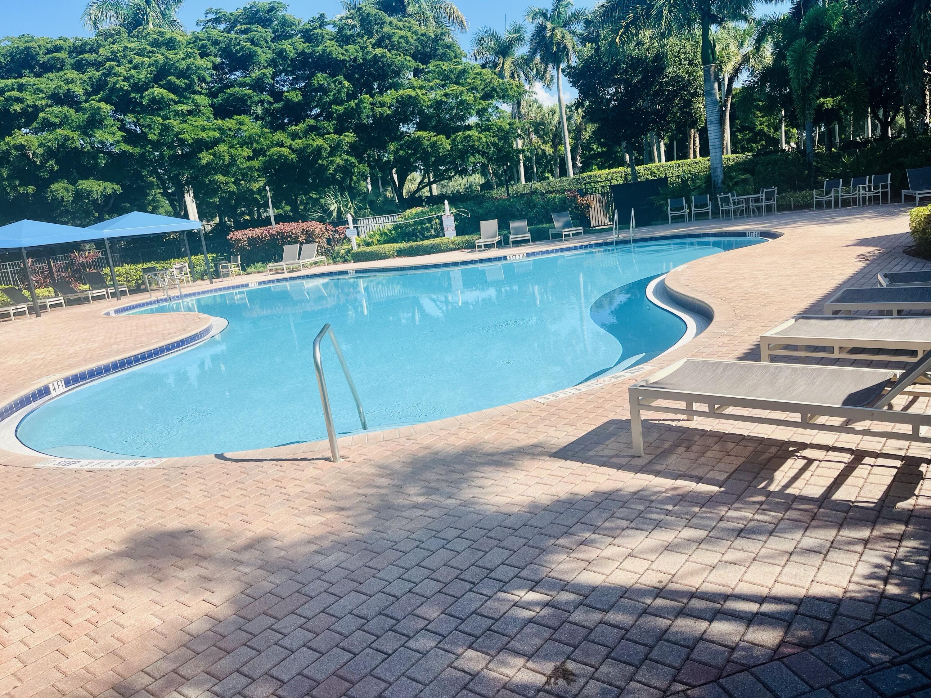 5200 Rising Comet Lane Greenacres, FL 33463 - Photo 37 of 50 a view of a swimming pool with a patio