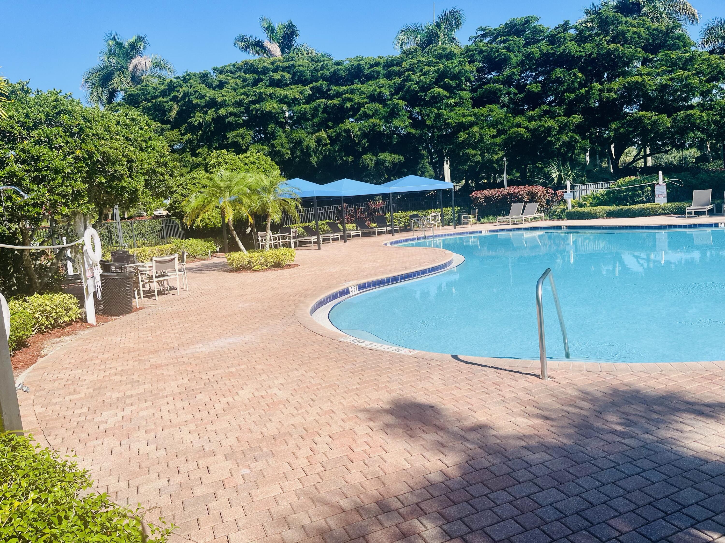 5200 Rising Comet Lane Greenacres, FL 33463 - Photo 38 of 50 a view of a swimming pool with a patio