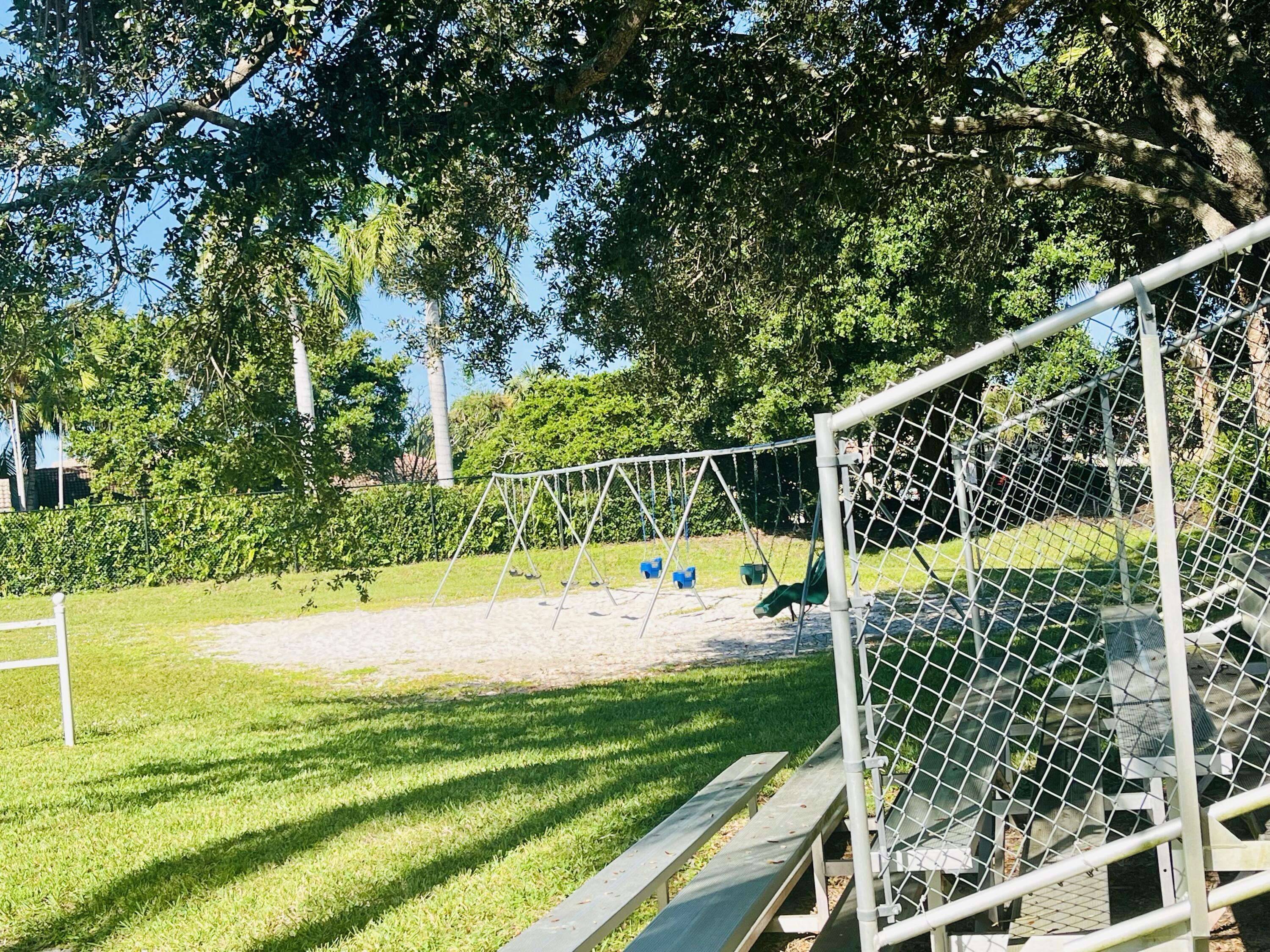5200 Rising Comet Lane Greenacres, FL 33463 - Photo 47 of 50 a view of a yard with potted plants and large trees