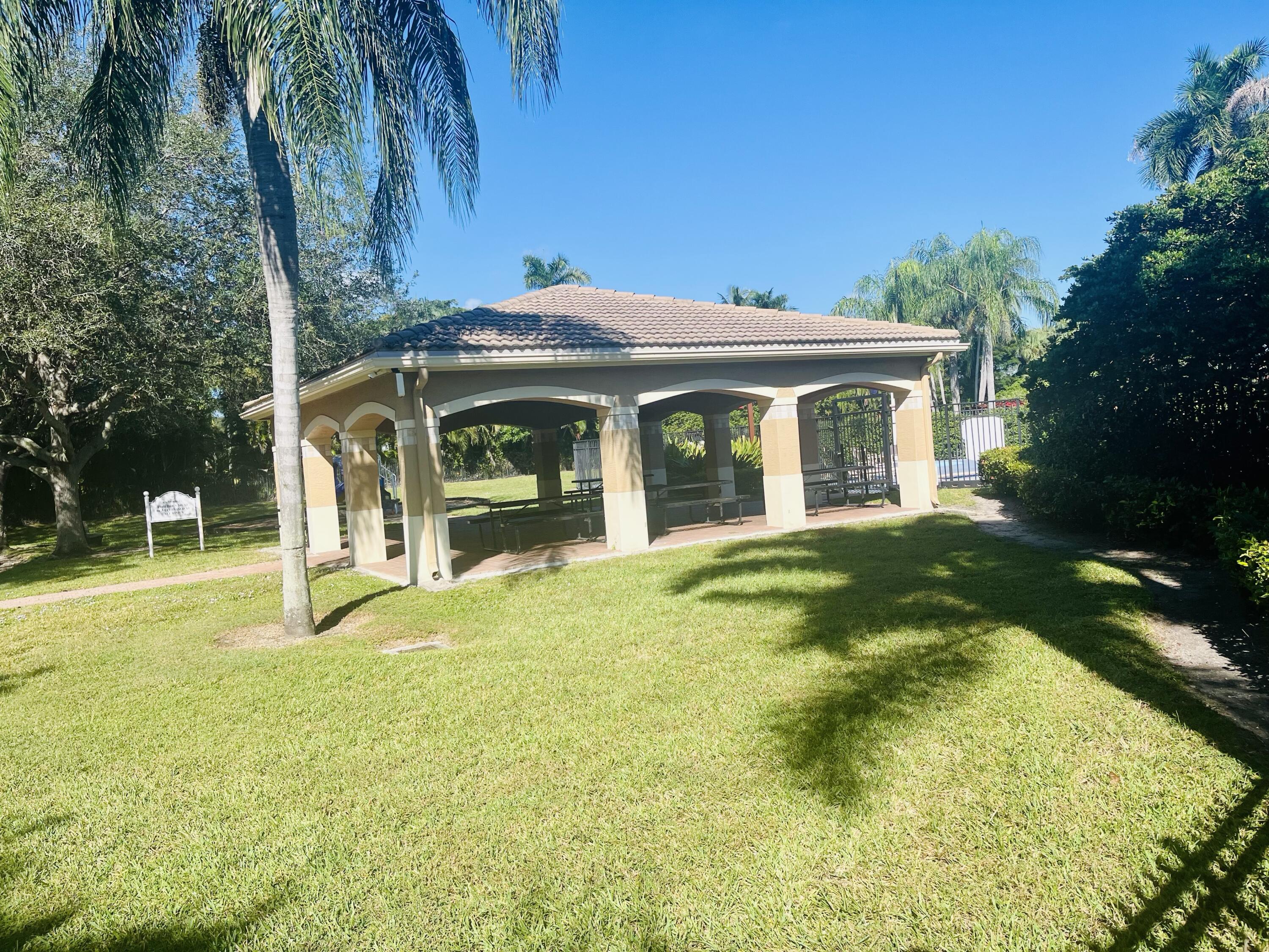 5200 Rising Comet Lane Greenacres, FL 33463 - Photo 48 of 50 front view of a house with a yard