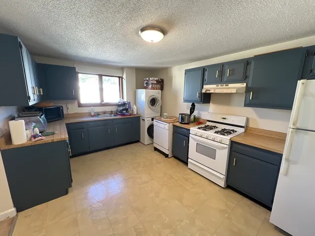 a kitchen with stove top oven and sink