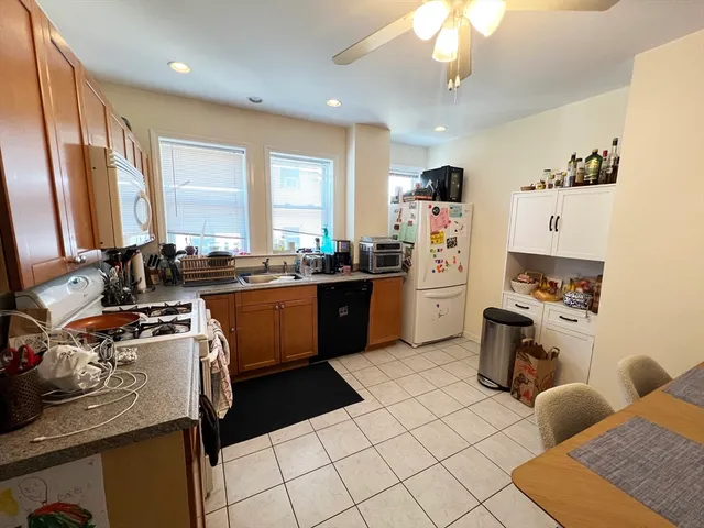 a kitchen with a sink appliances and cabinets