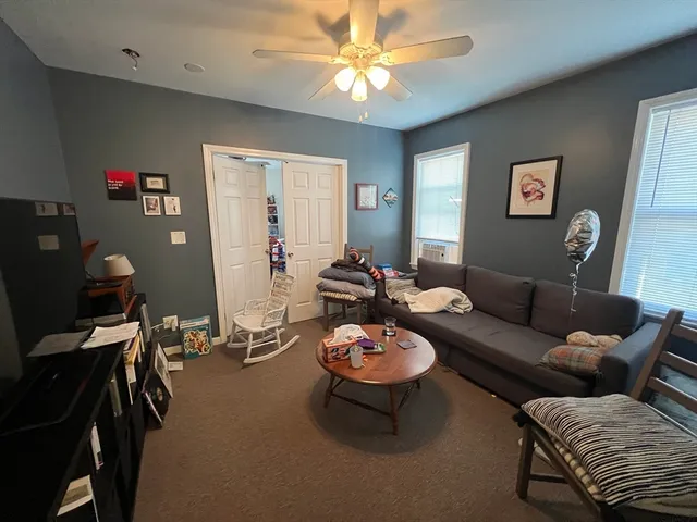 a living room with furniture a chandelier and a window