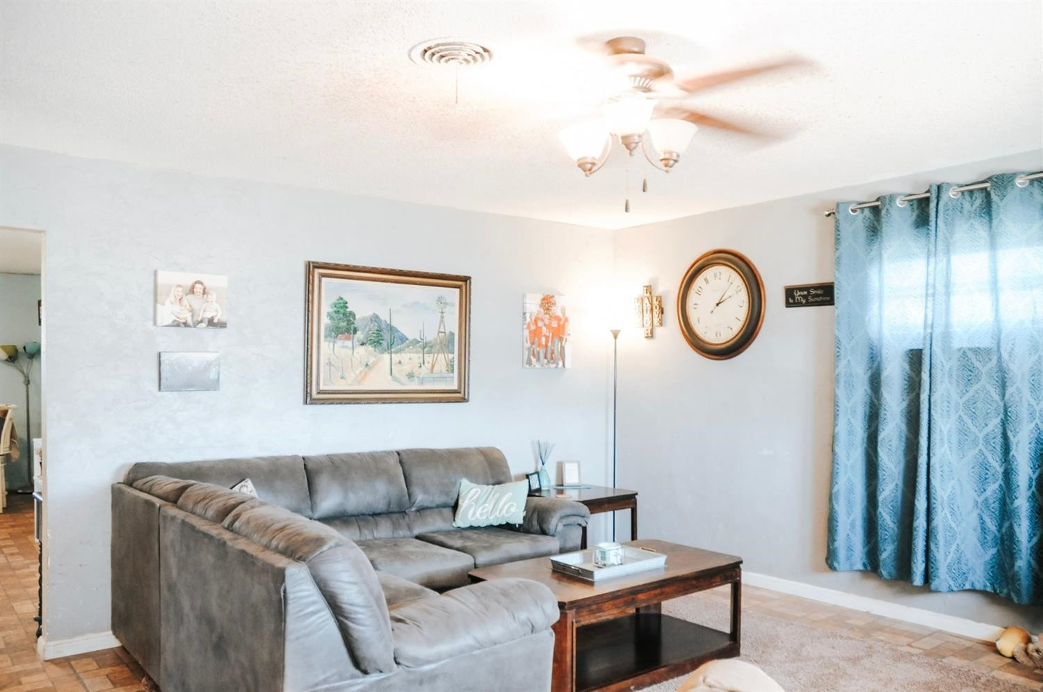 309 Ranch Street Ropesville, TX 79358 - Photo 3 of 26 a living room with couches a wall painting and a clock